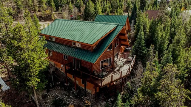 an aerial view of a house with a yard and deck