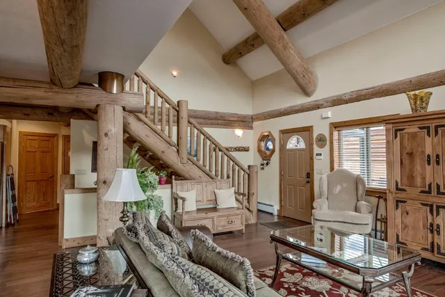 a view of entryway livingroom and hall with wooden floor