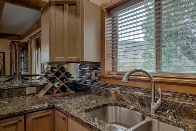a kitchen with a sink a counter top space and cabinets