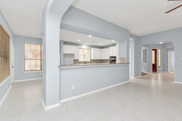 a view of a kitchen with a sink and cabinets