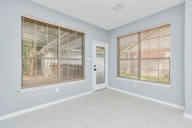 a view of an empty room with a window