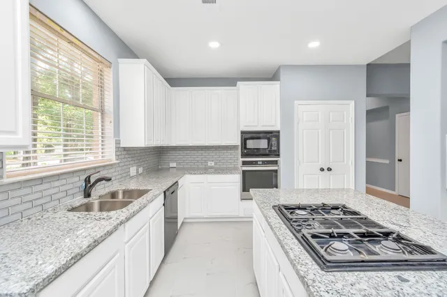 a kitchen with a stove a sink and a refrigerator