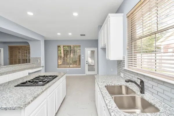 a kitchen with a stove a sink and a refrigerator