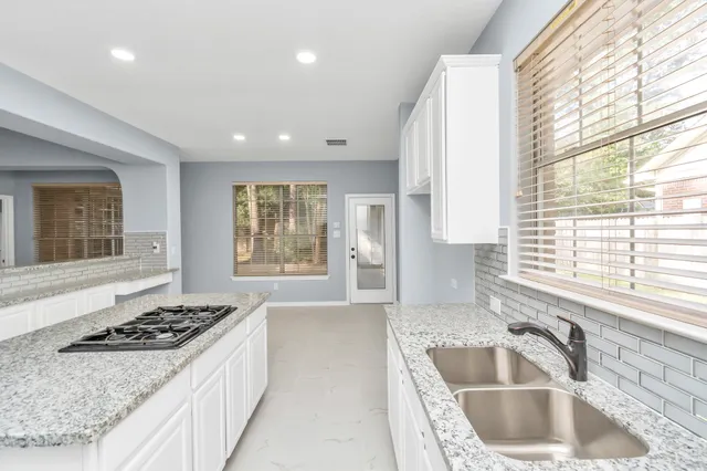 a kitchen with a stove a sink and a refrigerator