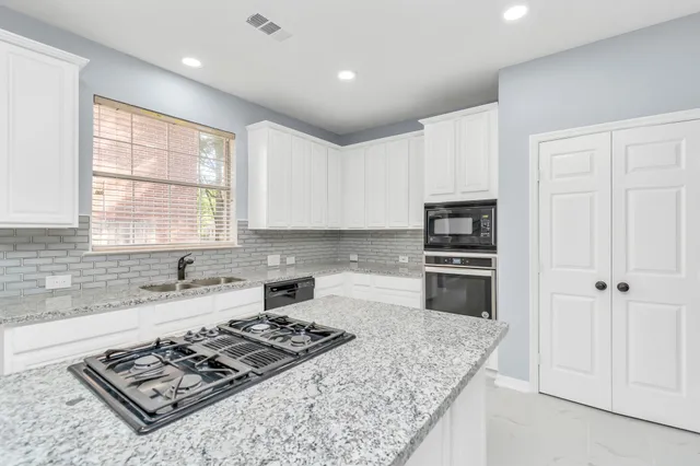 a kitchen with a stove a sink and a refrigerator