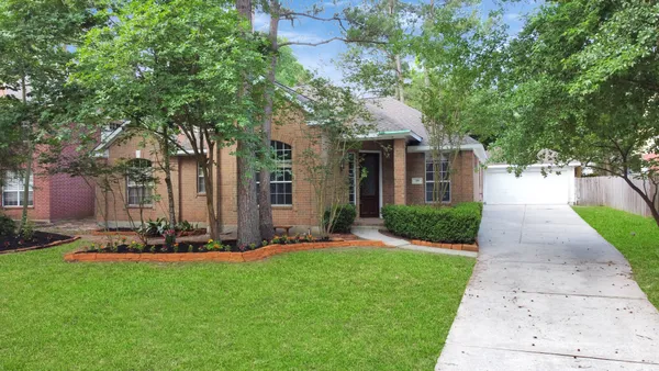 a front view of house with yard and green space