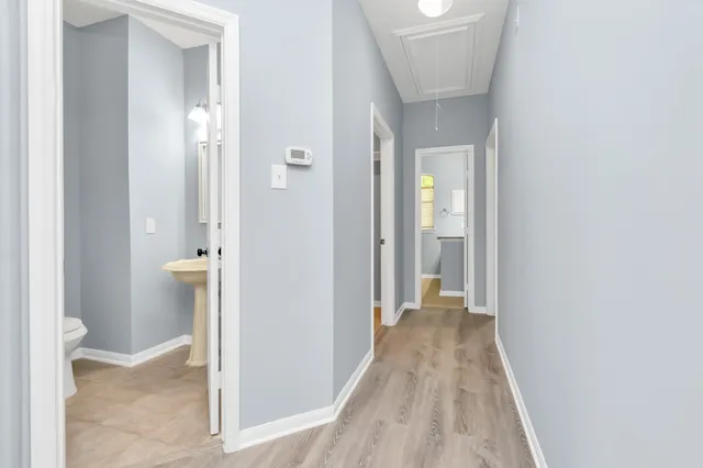 a view of a hallway with wooden floor
