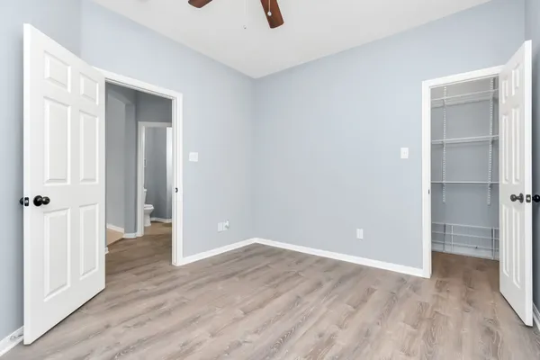 a view of an empty room with wooden floor
