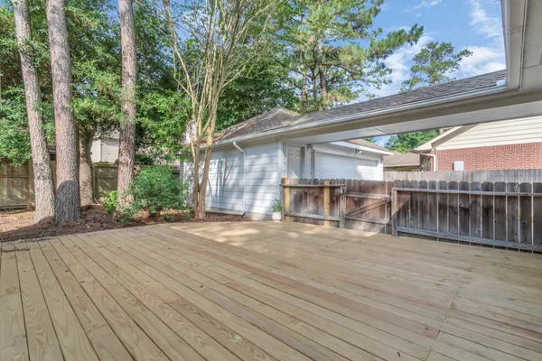 a view of a patio with table and chairs and wooden floor