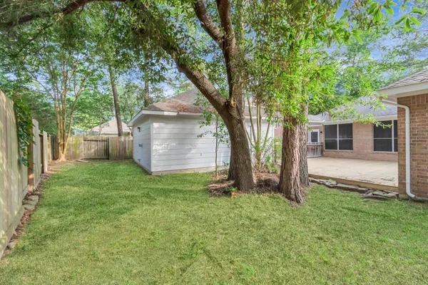 a view of a backyard with a large tree