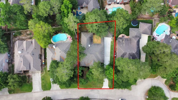an aerial view of a house with a yard and garden