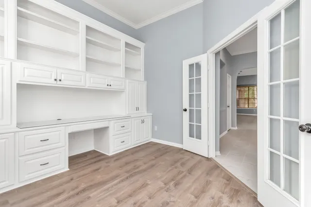 wooden floor with white cabinets and wooden floors