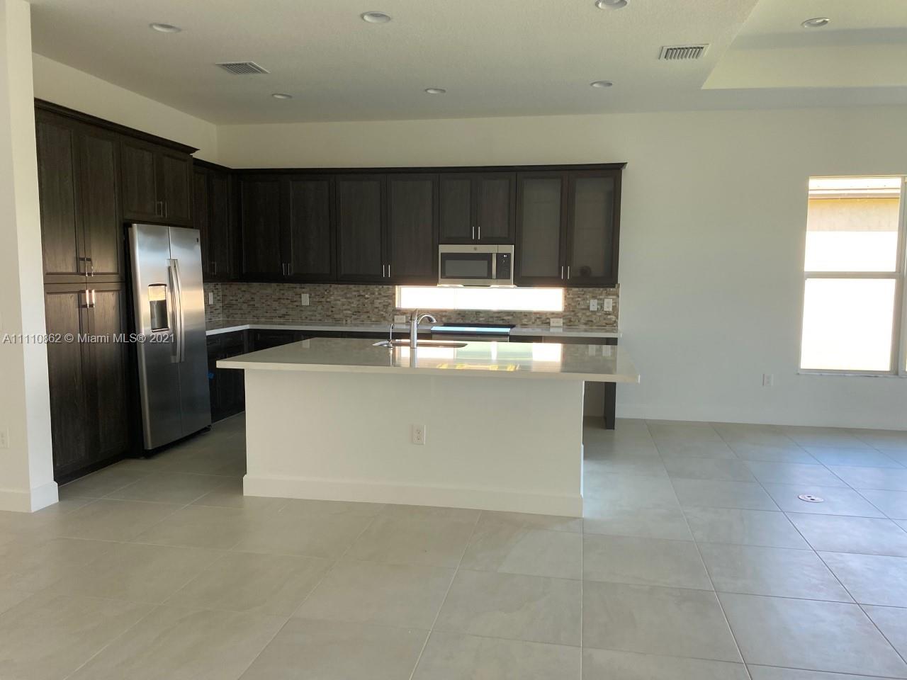 Polo Trace Delray Beach, FL 33446 - Photo 13 of 40 a kitchen with stainless steel appliances granite countertop a stove a refrigerator and a sink
