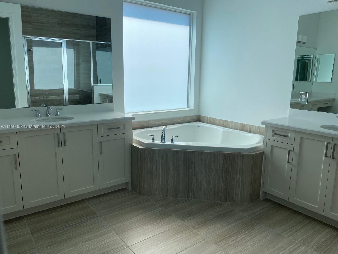 Polo Trace Delray Beach, FL 33446 - Photo 19 of 40 a bathroom with a sink and a mirror
