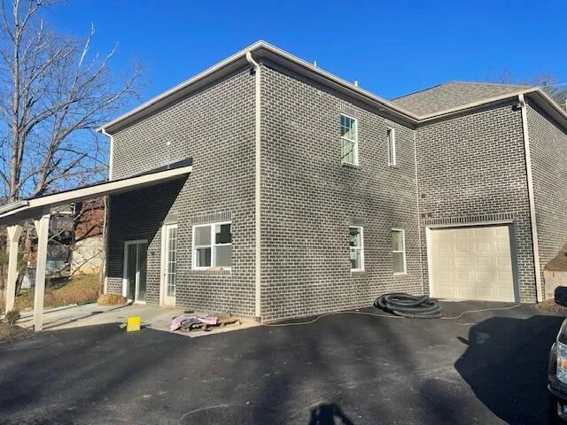 a front view of a house with a road