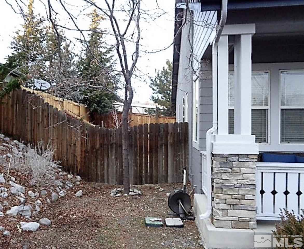 5555 Tappan Drive Reno, NV 89523 - Photo 3 of 11 a view of a house with a large trees and wooden fence