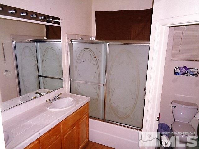 5555 Tappan Drive Reno, NV 89523 - Photo 10 of 11 a bathroom with a sink a toilet and shower