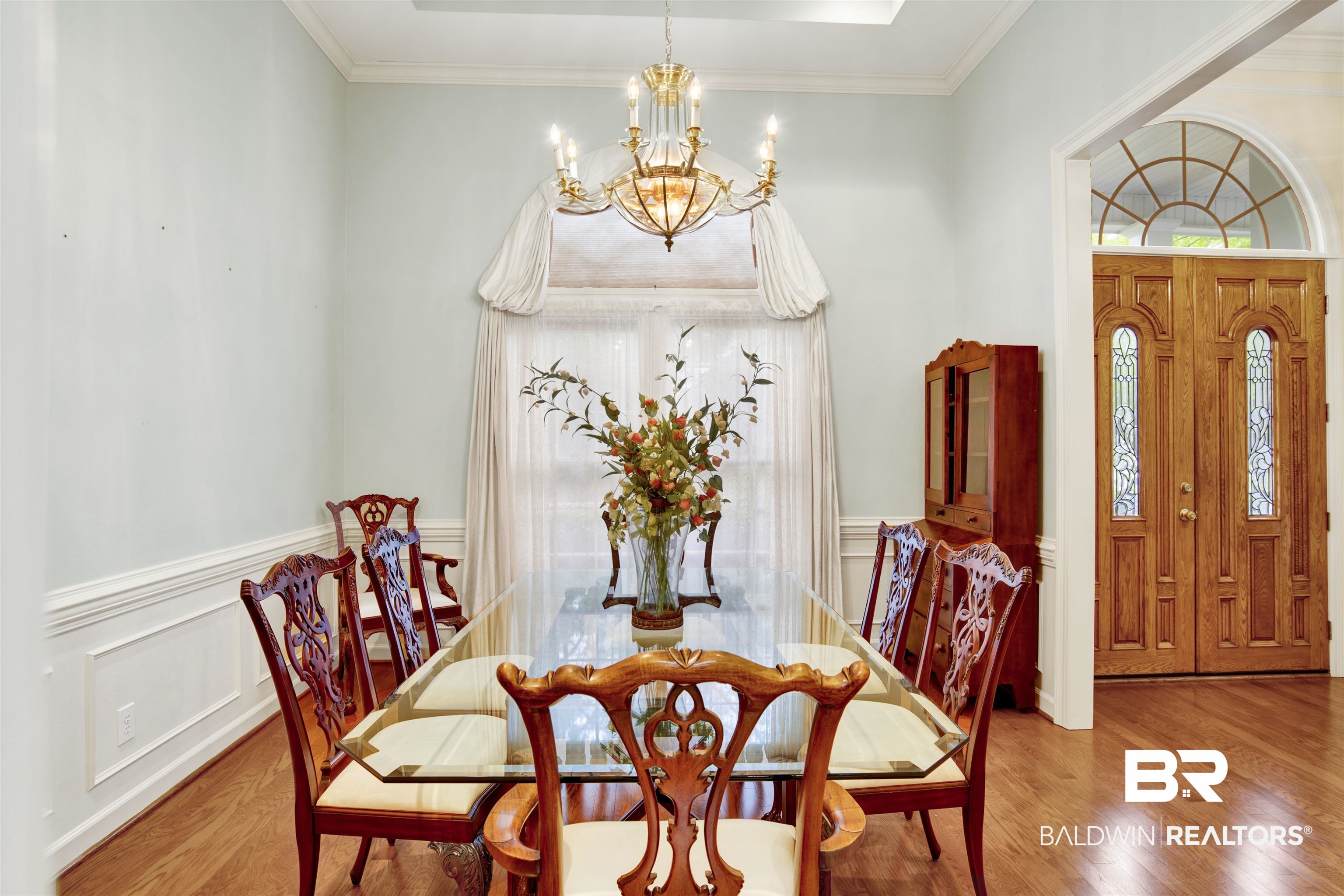 106 Old Mill Road Fairhope, AL 36532 - Photo 7 of 49 Dining room with a notable chandelier, wood finished floors, and wainscoting