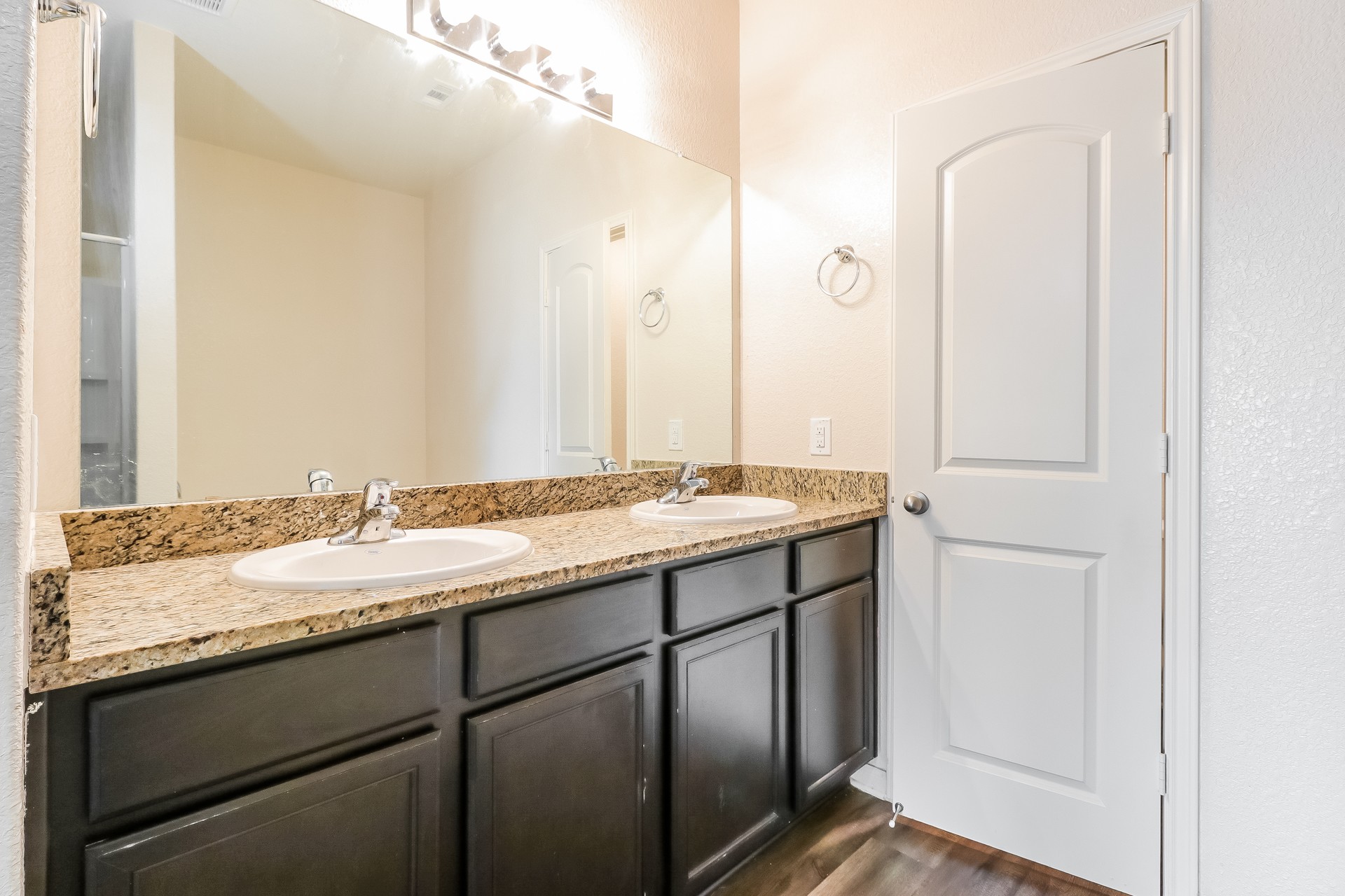 20017 Hubert R Humphrey Road Manor, TX 78653 - Photo 11 of 27 Granite counters and dual sinks provide ample space for daily routines in this bathroom.