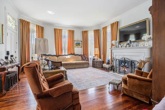 a living room with furniture and a book shelf