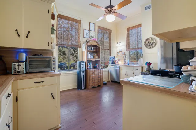 a kitchen with stainless steel appliances a white stove top oven and a refrigerator