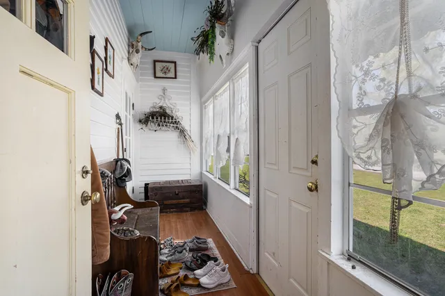 a spacious bedroom with a bed and a flat screen tv