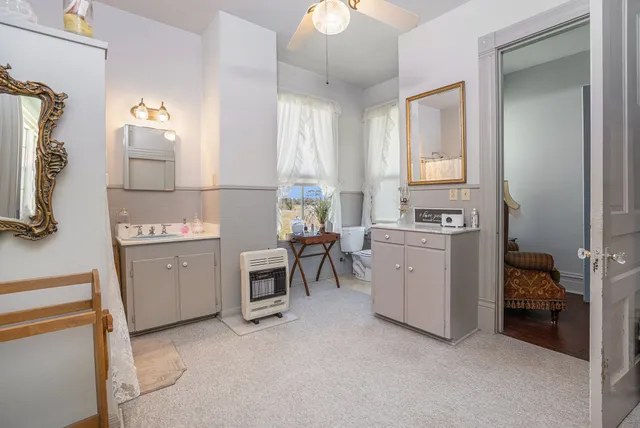 a bedroom with furniture and a flat screen tv