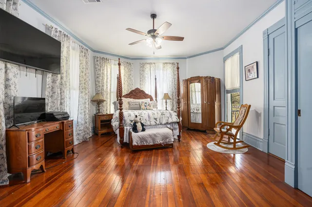 a view of an empty room with a fireplace and a window