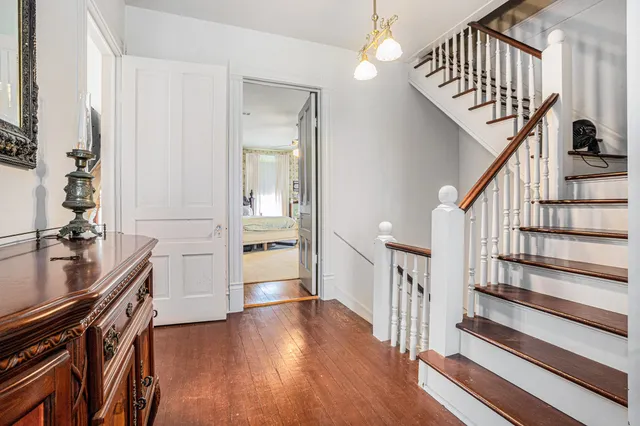 a view of entryway and hall with wooden floor
