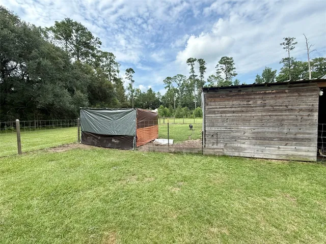 a view of a garage with wooden table and chairs