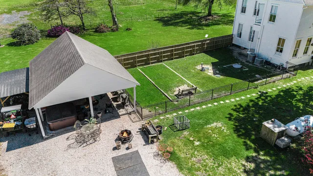 a view of the patio with table and chairs under an umbrella