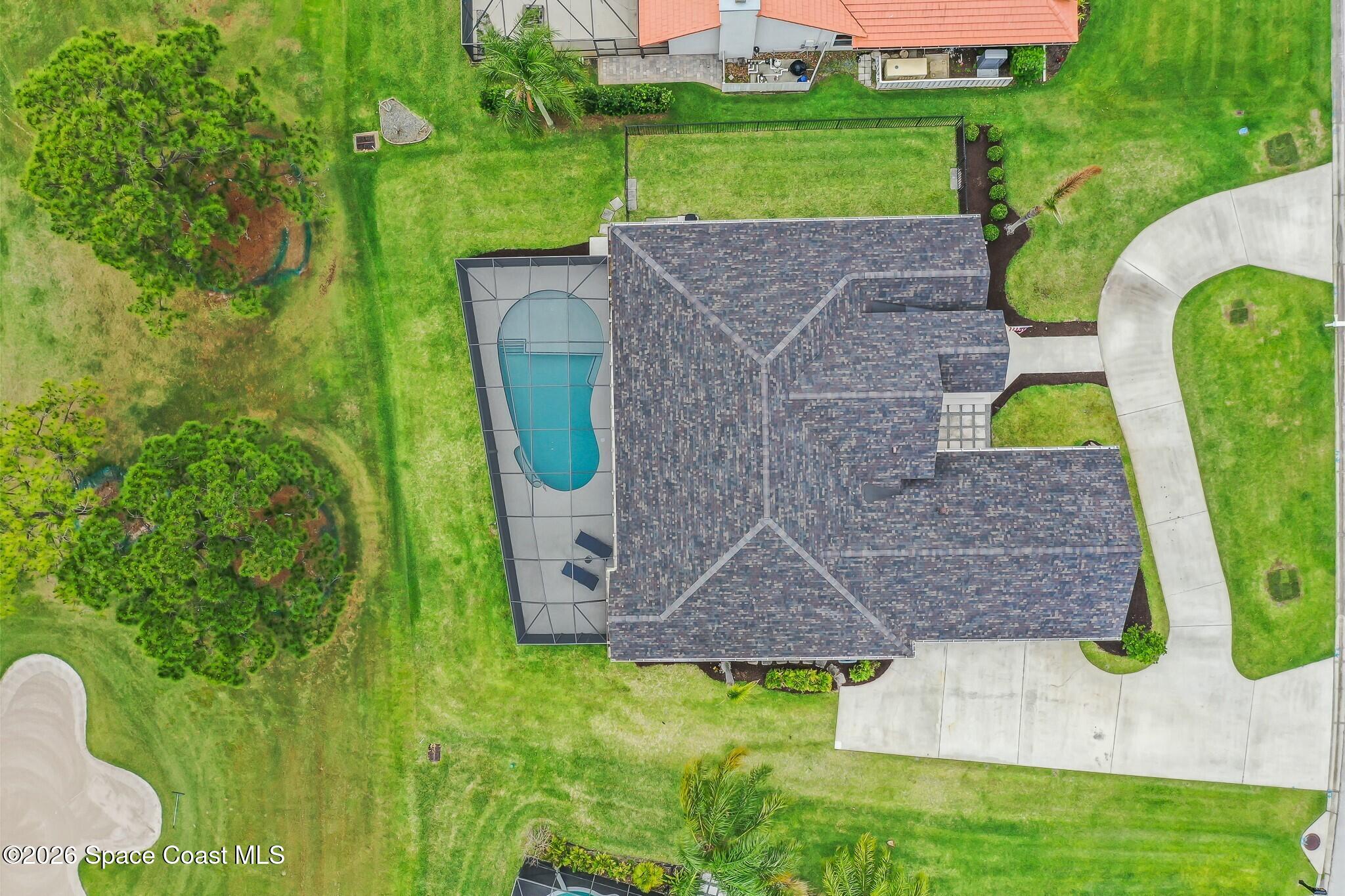 697 Spring Lake Drive Melbourne, FL 32940 - Photo 3 of 45 an aerial view of a house with a yard