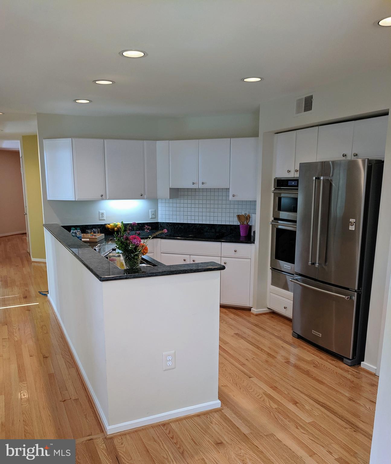 2272 Compass Point Lane Reston, VA 20191 - Photo 14 of 25 a kitchen with granite countertop a refrigerator and a stove top oven