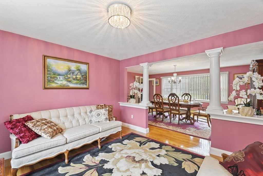 33 Old Farm Road Reading, MA 01867 - Photo 11 of 42 a living room with furniture and a large window