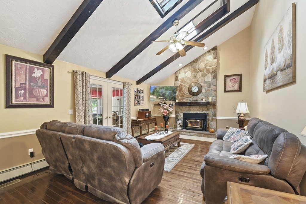 33 Old Farm Road Reading, MA 01867 - Photo 18 of 42 a living room with furniture a fireplace and a large window