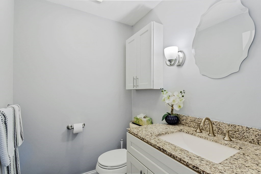 33 Old Farm Road Reading, MA 01867 - Photo 21 of 42 a bathroom with a granite countertop sink a toilet and mirror