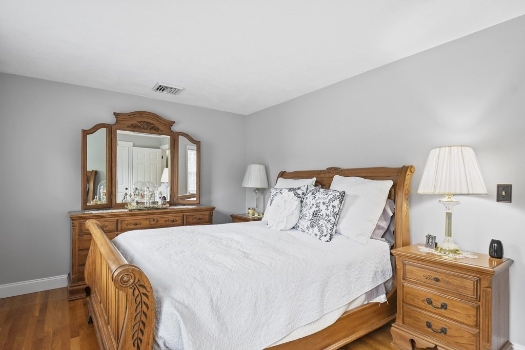 33 Old Farm Road Reading, MA 01867 - Photo 27 of 42 a bedroom with a bed and a dresser