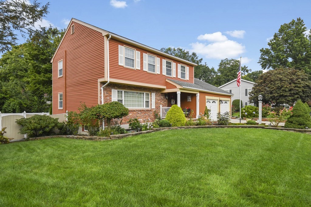 33 Old Farm Road Reading, MA 01867 - Photo 3 of 42 a front view of a house with a garden and yard