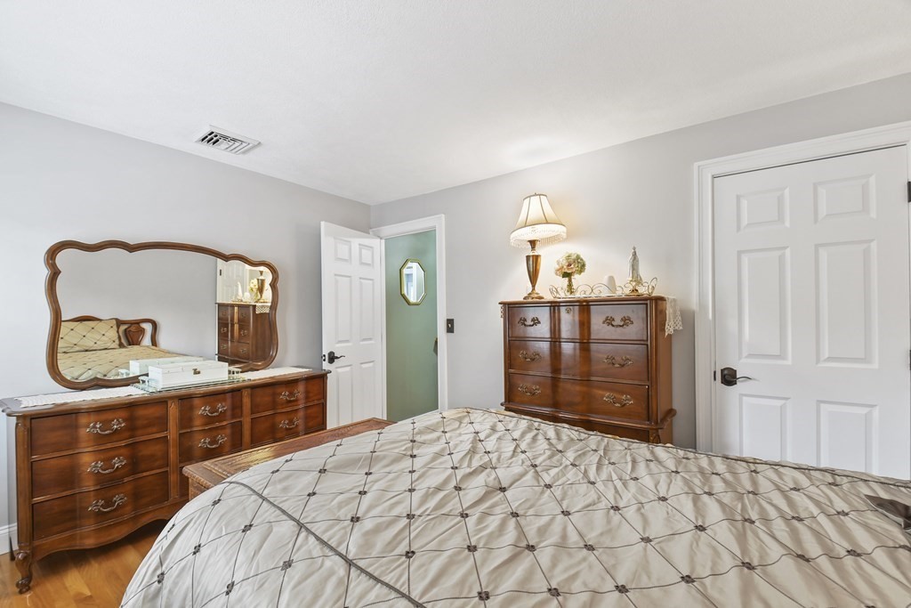 33 Old Farm Road Reading, MA 01867 - Photo 32 of 42 a bedroom with a bed and a dresser