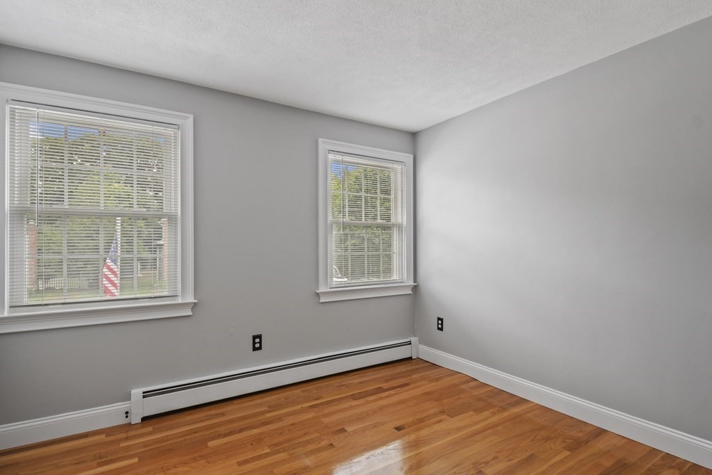 33 Old Farm Road Reading, MA 01867 - Photo 33 of 42 a view of an empty room with wooden floor and a window