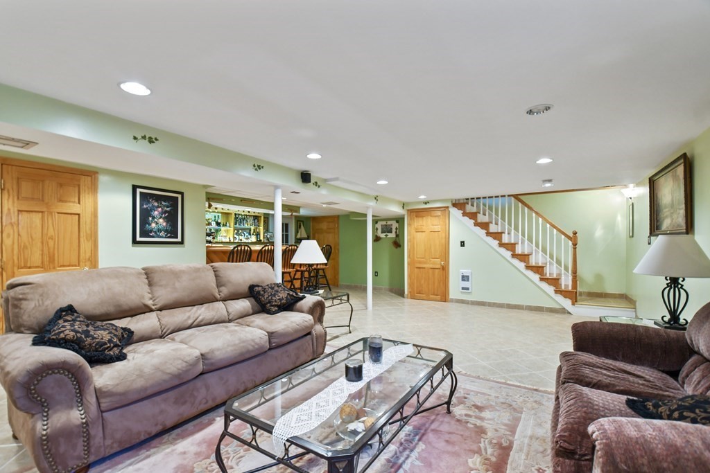 33 Old Farm Road Reading, MA 01867 - Photo 37 of 42 a living room with furniture and a wooden floor