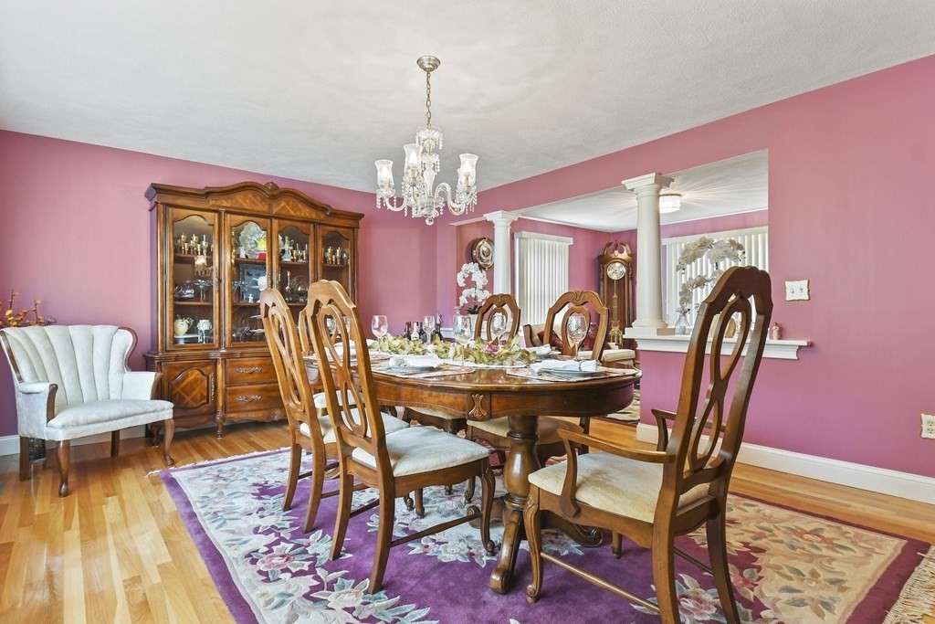 33 Old Farm Road Reading, MA 01867 - Photo 7 of 42 a view of a dining room with furniture wooden floor and chandelier