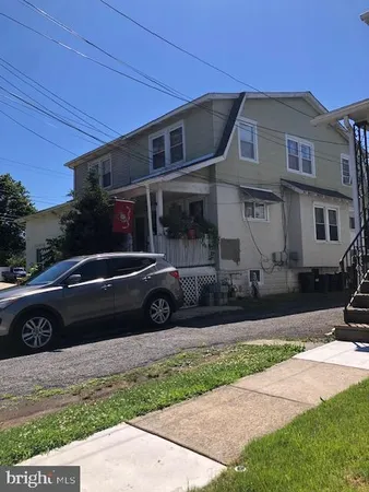 a view of a car parked in front of a house