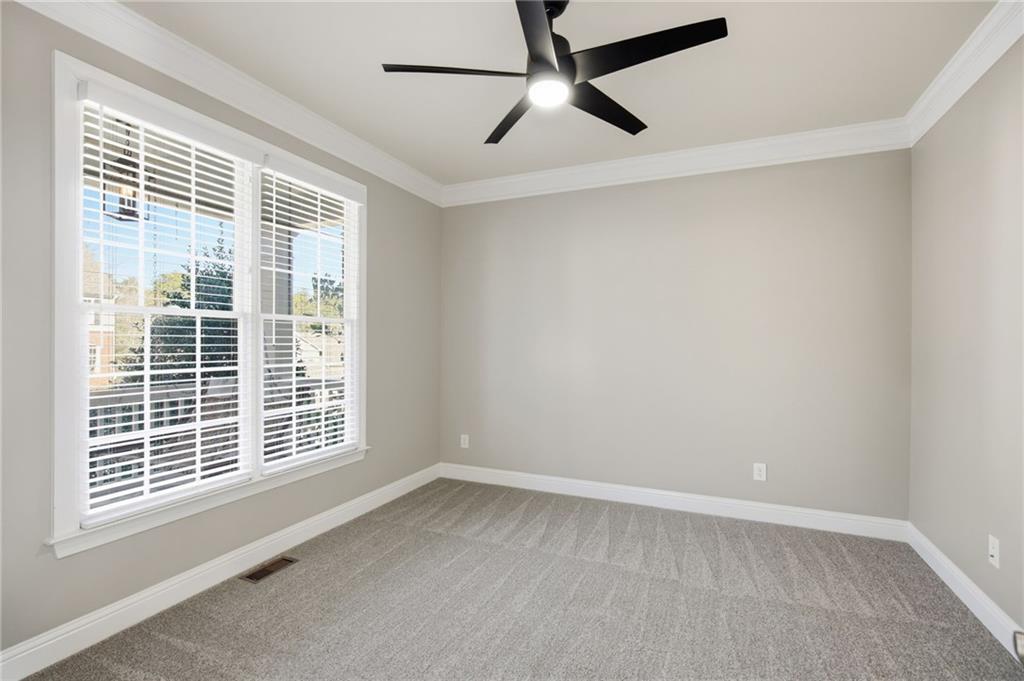 1830 Callaway Ridge Drive Northwest Kennesaw, GA 30152 - Photo 12 of 60 an empty room with a window and a ceiling fan