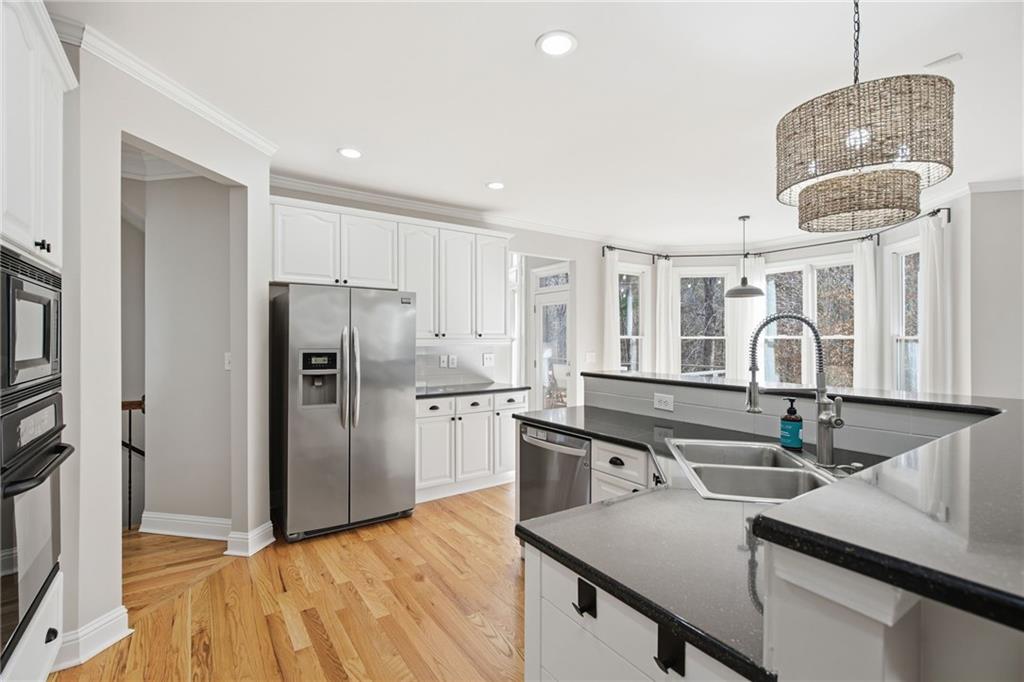 1830 Callaway Ridge Drive Northwest Kennesaw, GA 30152 - Photo 20 of 60 a kitchen with stainless steel appliances granite countertop a sink refrigerator and cabinets