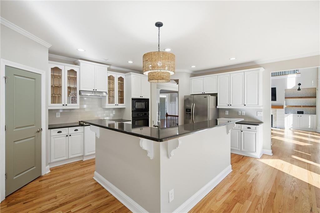 1830 Callaway Ridge Drive Northwest Kennesaw, GA 30152 - Photo 21 of 60 a kitchen with stainless steel appliances granite countertop a refrigerator and a stove top oven