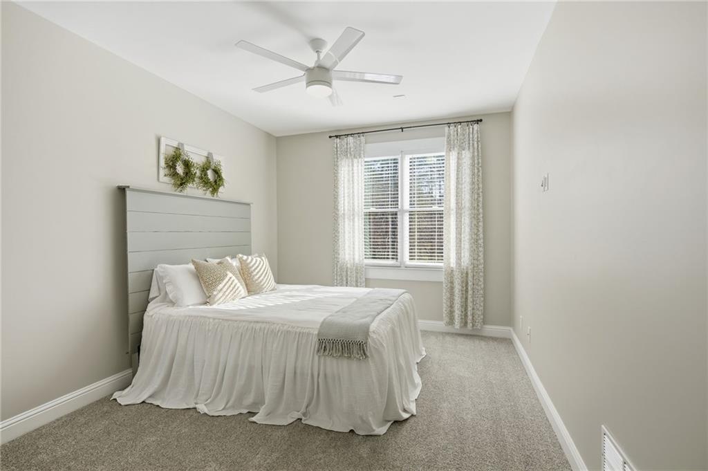 1830 Callaway Ridge Drive Northwest Kennesaw, GA 30152 - Photo 25 of 60 a bedroom with a bed painting on wall and a window