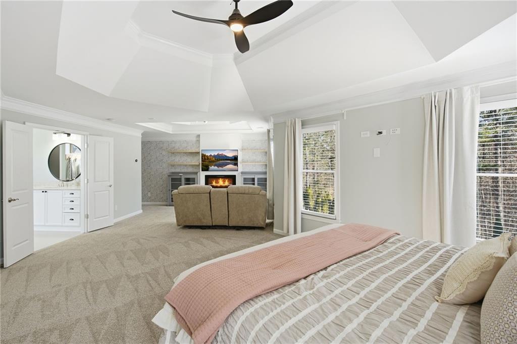 1830 Callaway Ridge Drive Northwest Kennesaw, GA 30152 - Photo 28 of 60 a bedroom with a bed a mirror on dresser and a window