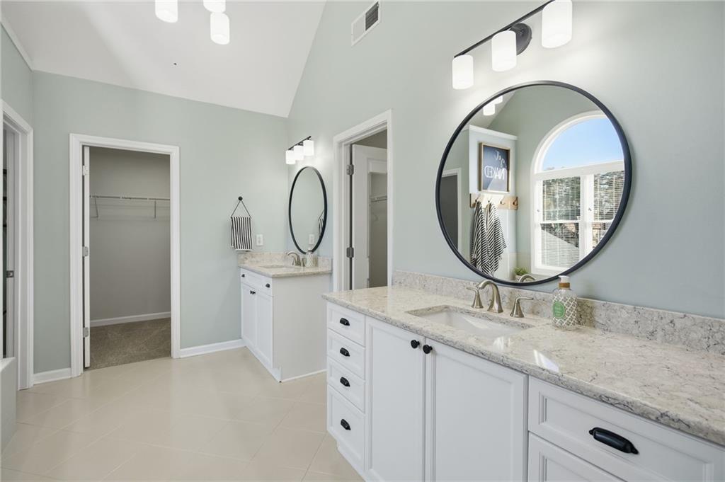 1830 Callaway Ridge Drive Northwest Kennesaw, GA 30152 - Photo 29 of 60 a bathroom with a granite countertop double vanity sink and a mirror