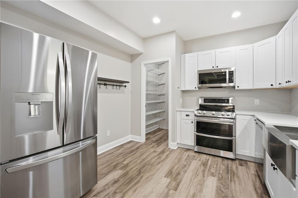 1830 Callaway Ridge Drive Northwest Kennesaw, GA 30152 - Photo 42 of 60 a kitchen with stainless steel appliances a refrigerator stove and microwave